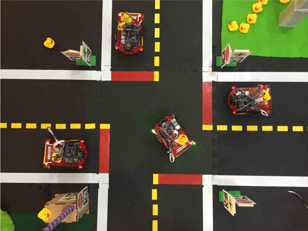 DuckieNet, a platform focused on autonomous vehicle fleets operating in model urban environments
